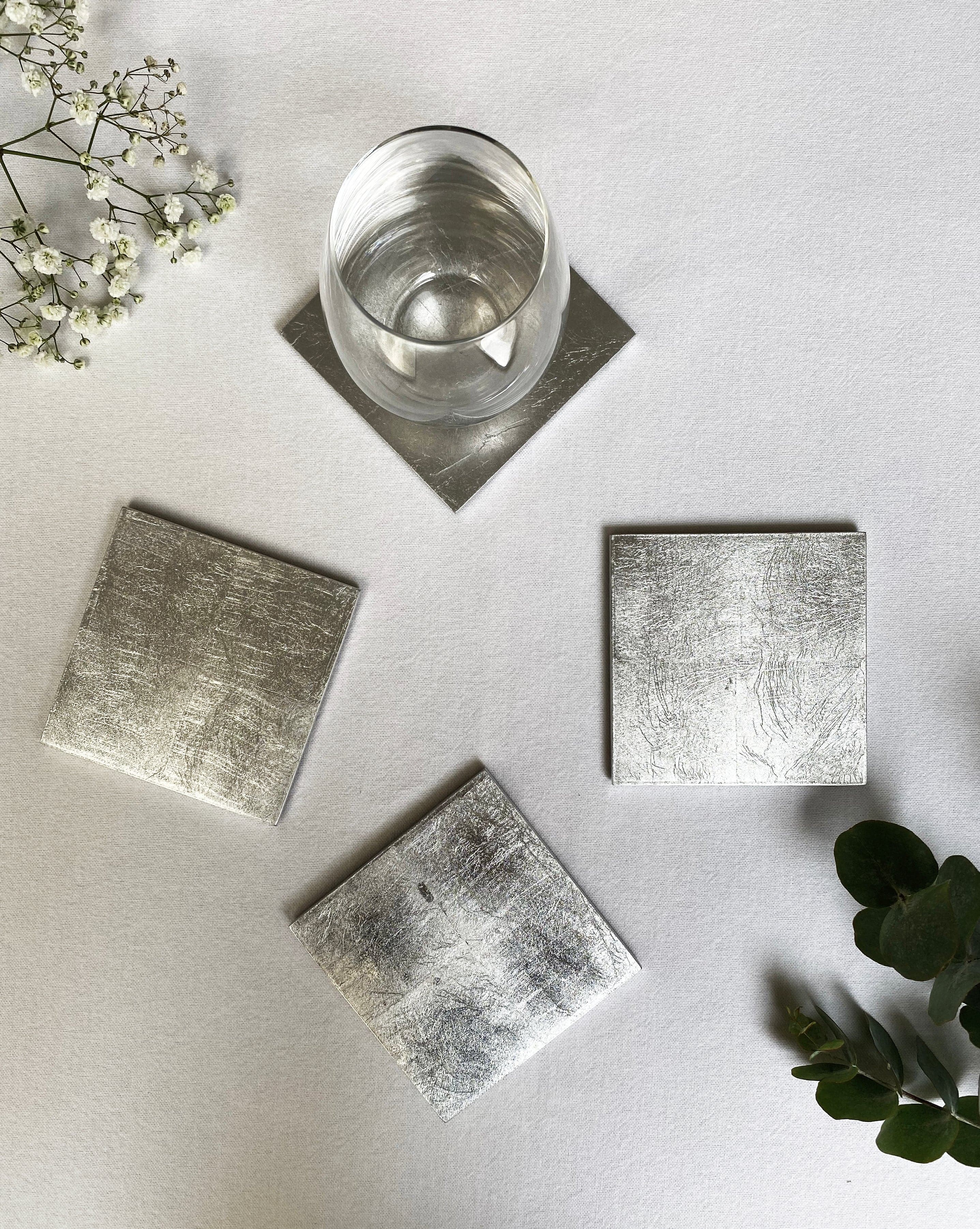 silver coasters arranged on a table surface